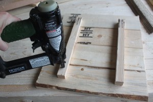 Nail the backer boards to pallet wood to stabilize your sign.