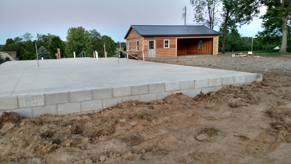 With the garage complete in the background., the foundation for the house sits ready for the builders this week!