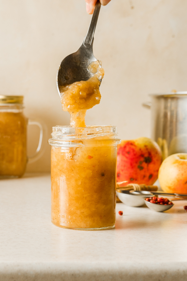 filling jar with applesauce