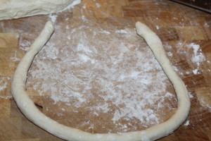 Roll out dough - approximately 20 inches in length then begin to shape into a pretzel shape.