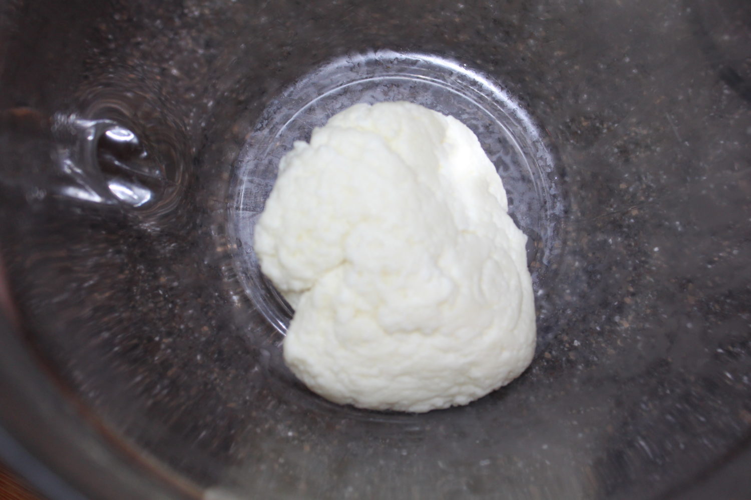 Heating the cheese in the microwave will allow more whey to release - leaving you with mozarella cheese