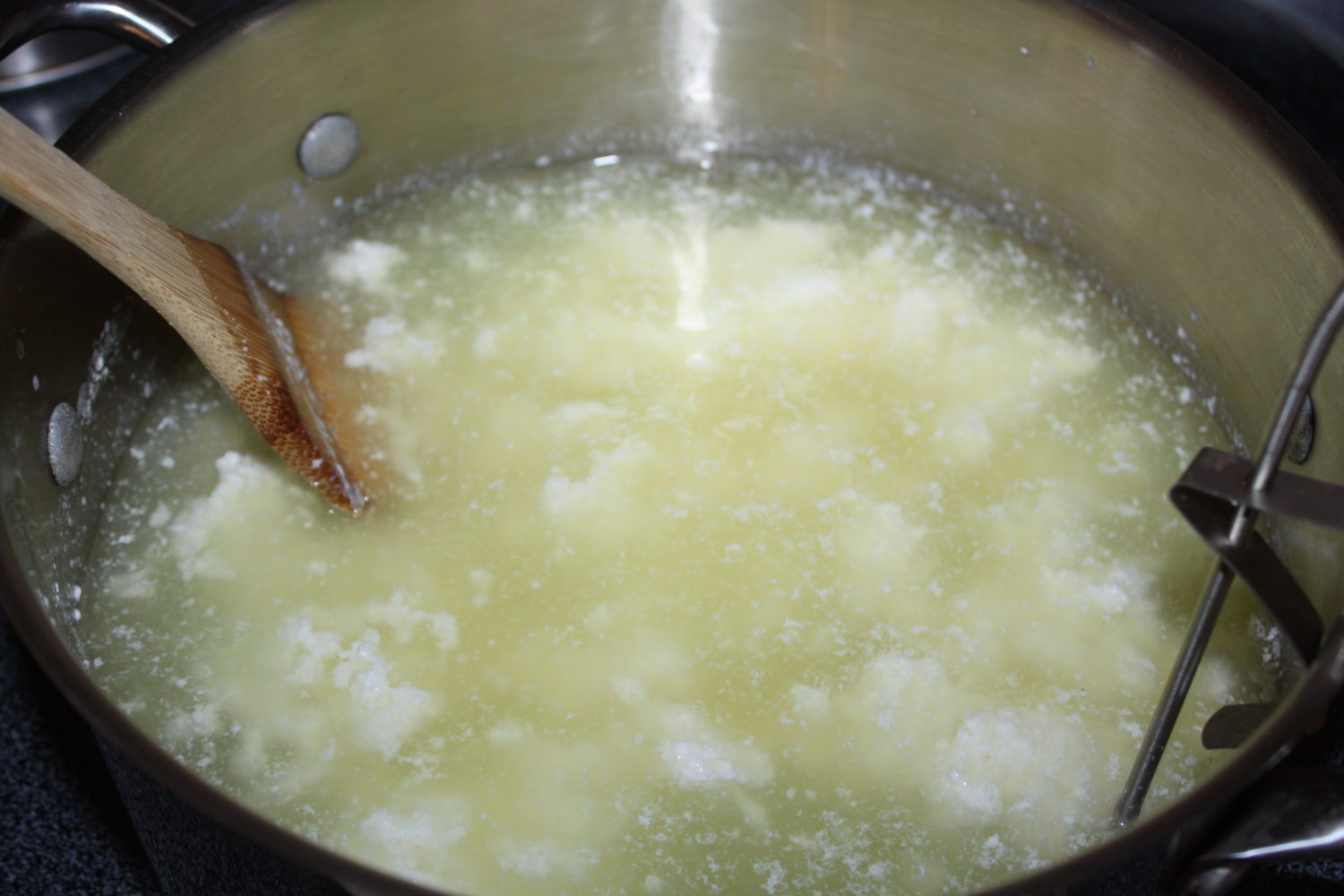 Heating the curds to 105 degrees F causes the whey to separate from the cheese. 