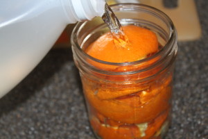 Pour the vinegar over the orange peels until it reaches the rim. 