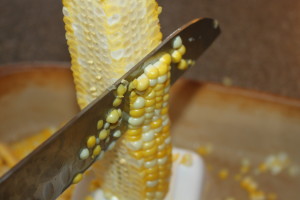 After placing the cob in ice water, cut off kernels 3/4 of the way from the cob. 