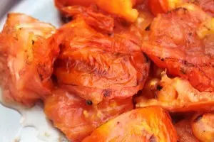 Place charred tomatoes in a bowl and cover with a towel so that the skins can be easily removed. 