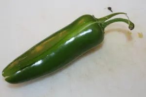 Cut the jalapenos in half lengthwise, including the stem. 