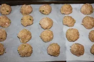 Place meatballs on a parchment paper lined baking sheet for easy clean up.
