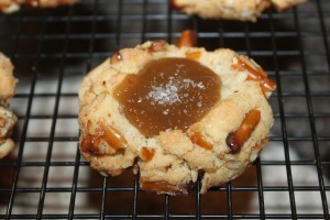 Pretzel cookie sits on the cooling rack filled with caramel