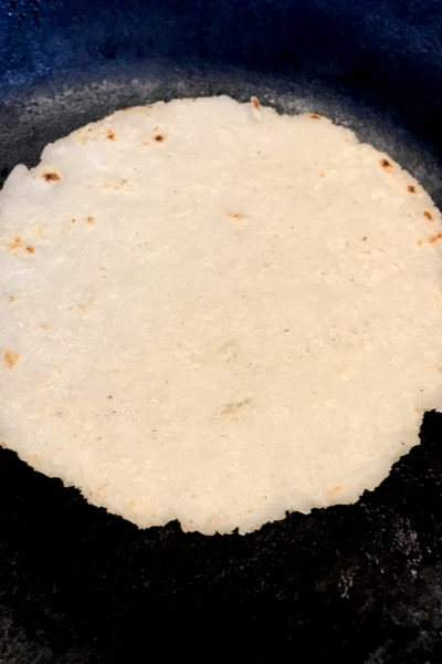 white corn tortilla in skillet 