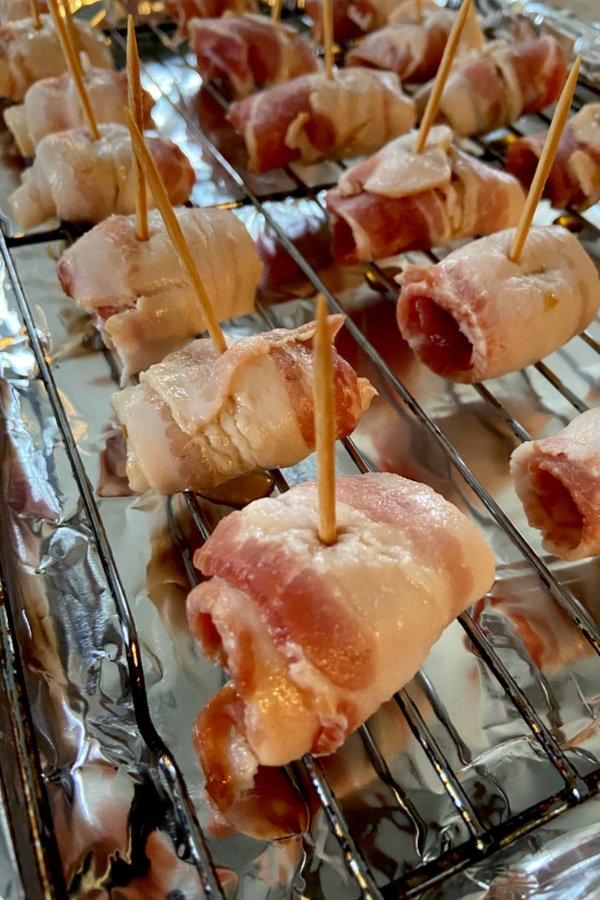 bacon wrapped water chestnuts on baking rack 