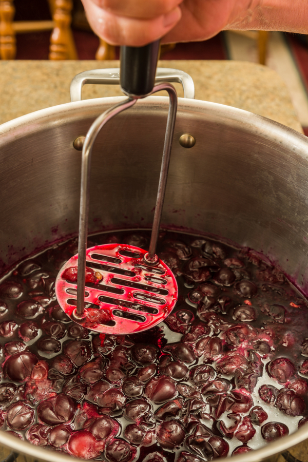 smashing grapes for homemade grape jelly