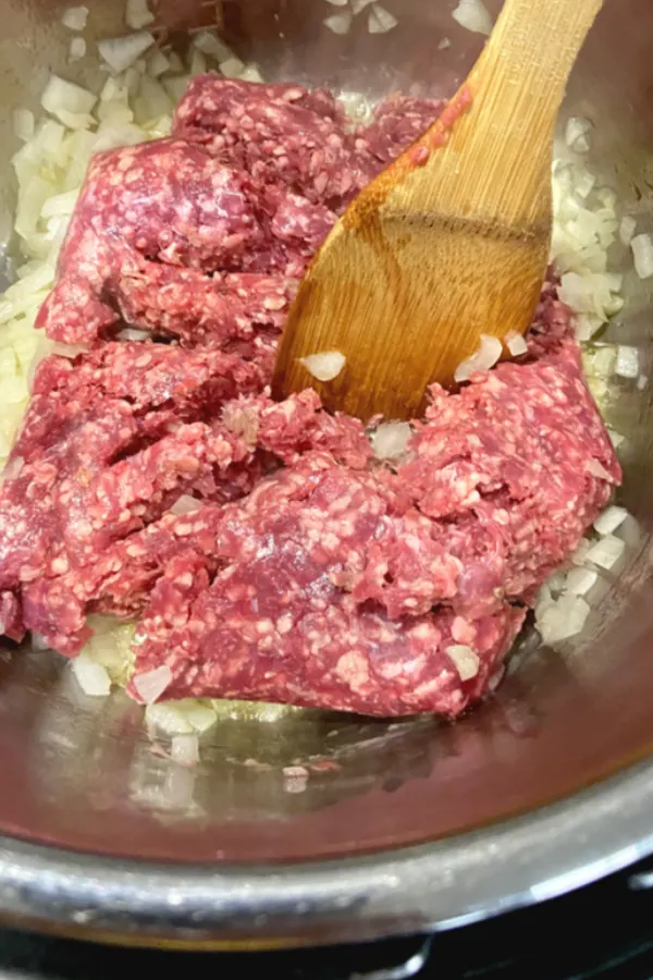 onions and ground beef in pot 