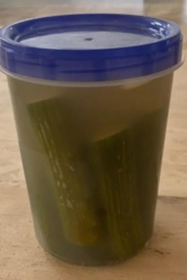 crock dill pickles in a plastic container 