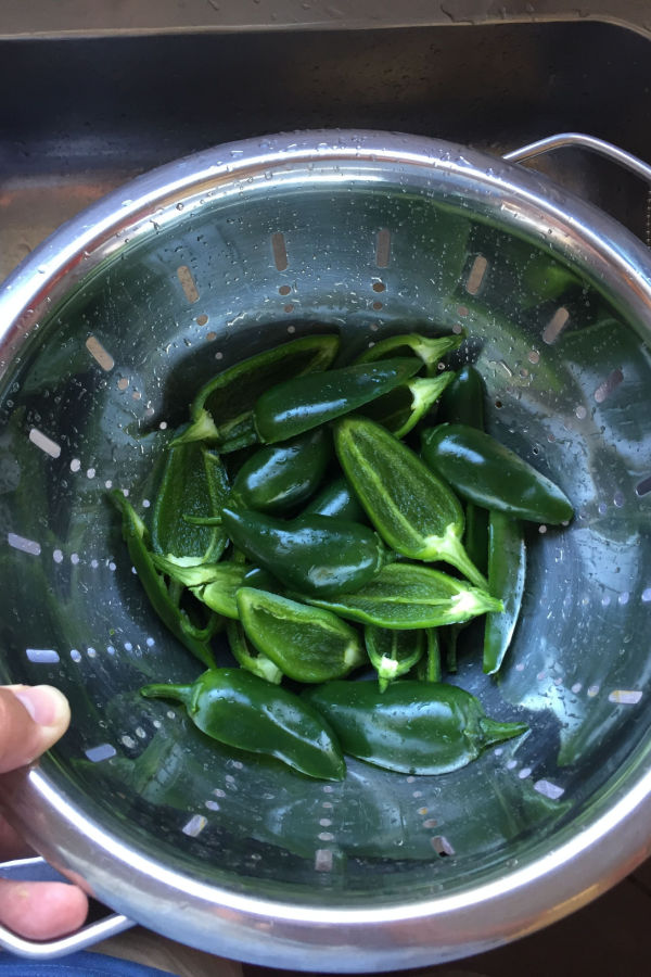 washing peppers in colander 