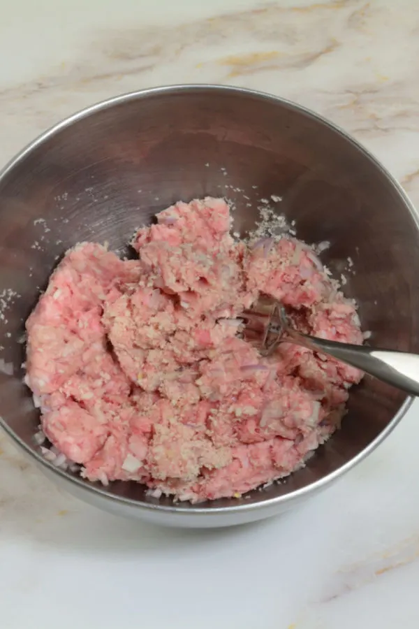 mixing meatloaf ingredients with a fork