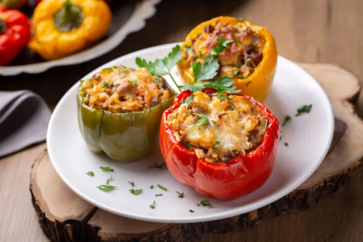 stuffed peppers with cheese on a white plate