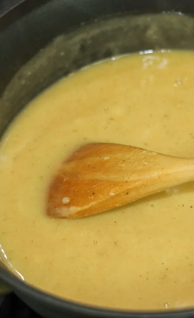 wooden spoon mixing a roux mixture