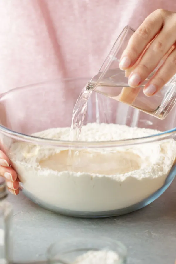 pouring water into flour 