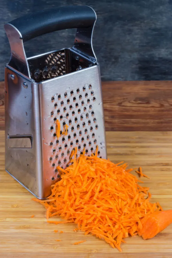 shredding carrots on box grater