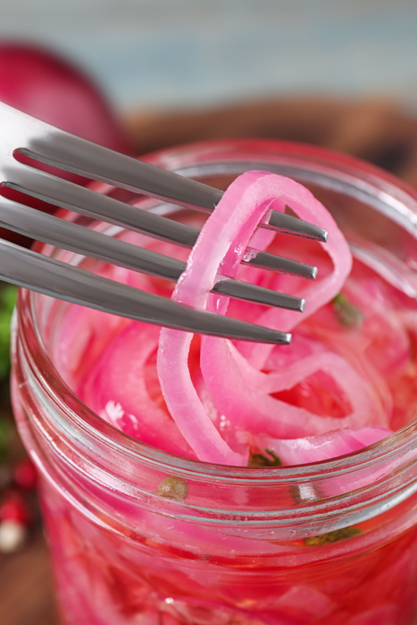 pickled red onions on a fork