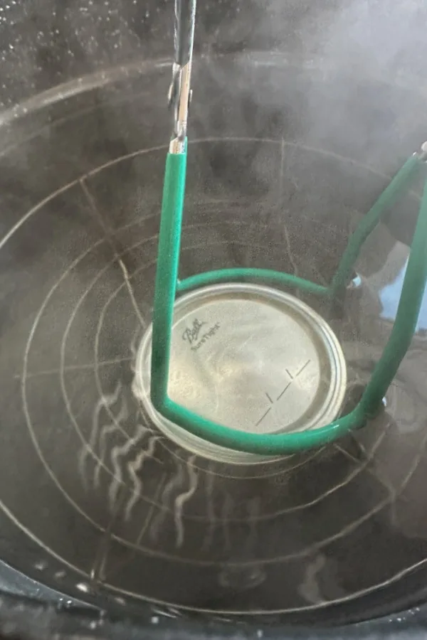 canning jar in hot water