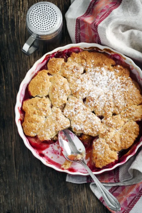 strawberry rhubarb cobbler with a serving missing